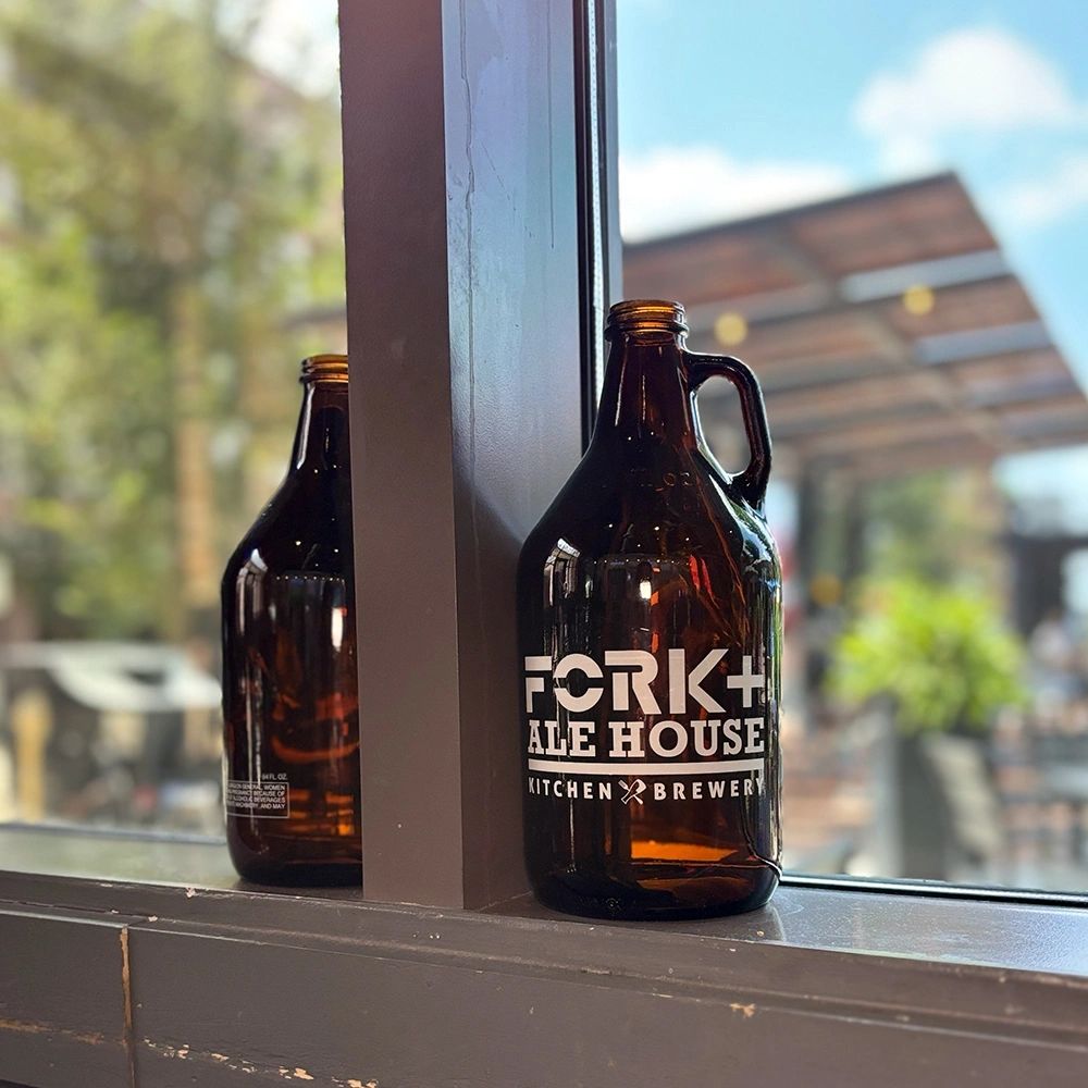 Fork + Ale House growlers beside a view of the patio